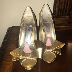 Paris Hilton gold bow heels